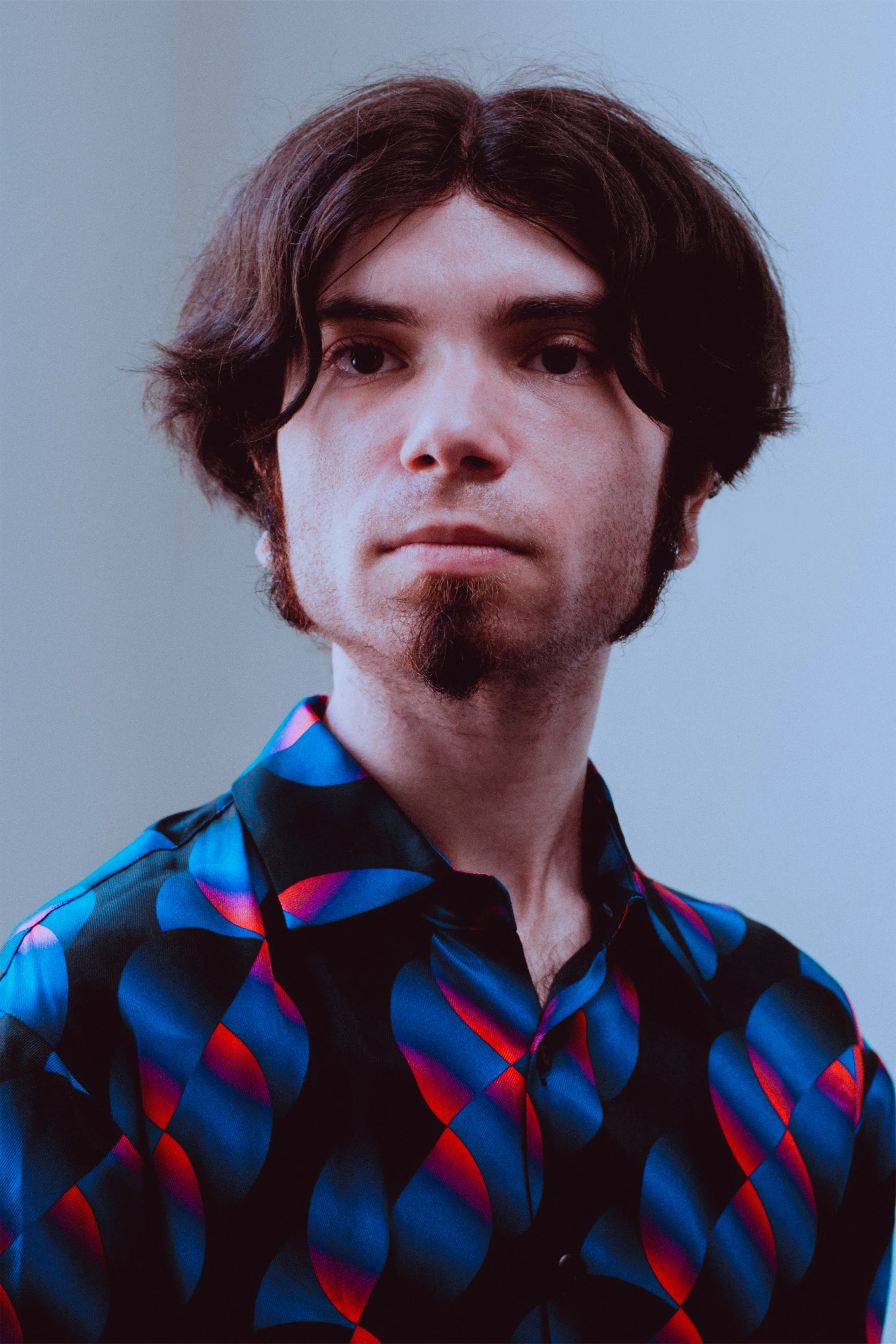 Zii in a blue-and-teal patterned shirt